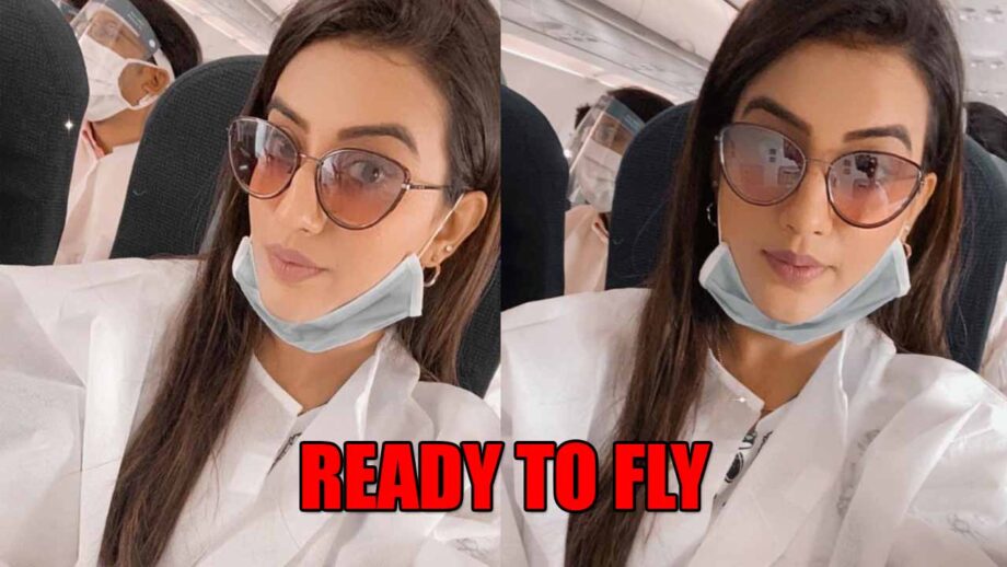 Watch Akshara Singh As She Takes A Flight Covered With Safety Clothes