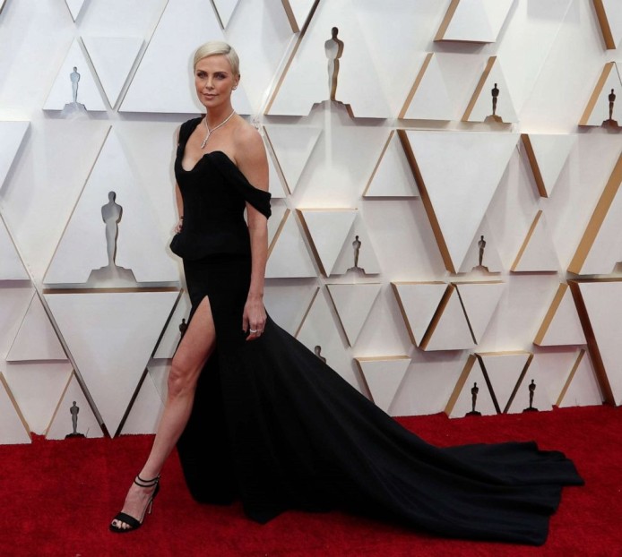 Charlize Theron Takes A Dramatic Fashion Turn In Monotone Train Gowns ...