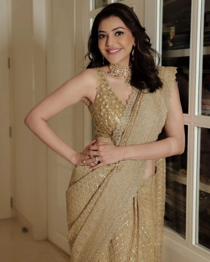 Kajal Aggarwal shines in her heavy embellished gold saree and plunge neck blouse design 853527