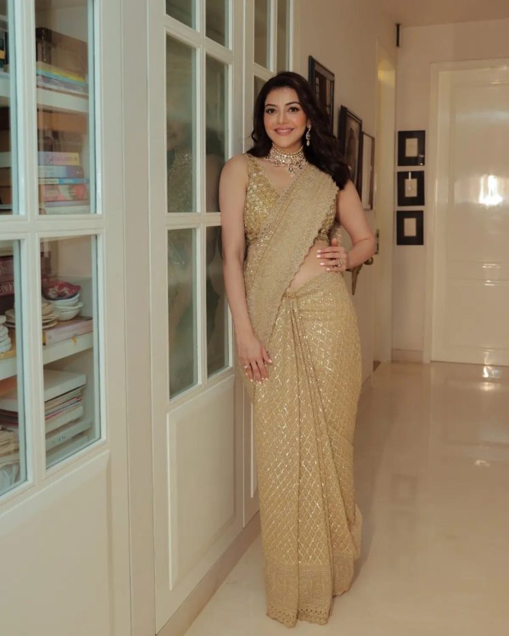 Kajal Aggarwal shines in her heavy embellished gold saree and plunge neck blouse design 853523