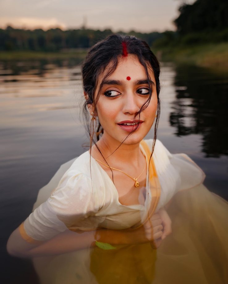 In Photos: Priya Varrier Looks Sizzling In Traditional White Saree As She Poses Inside Lake 861702