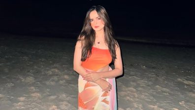 Palak Sindhwani Channels Mermaid Vibes in a Bold Orange Swimsuit by the Ocean