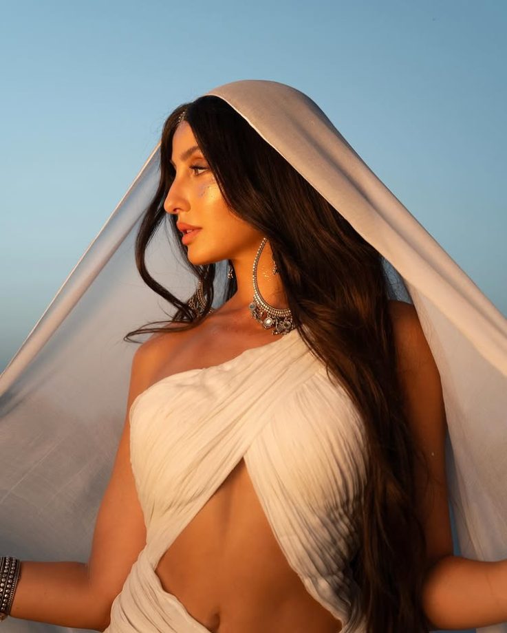 Nora Fatehi Illuminates in a One-Sided Halter White Dress 964358