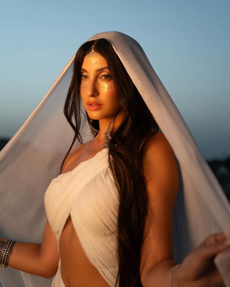 Nora Fatehi Illuminates in a One-Sided Halter White Dress 964359