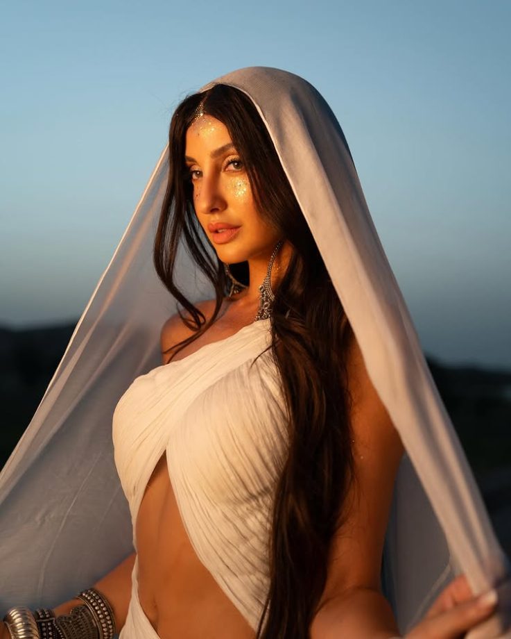 Nora Fatehi Illuminates in a One-Sided Halter White Dress 964357