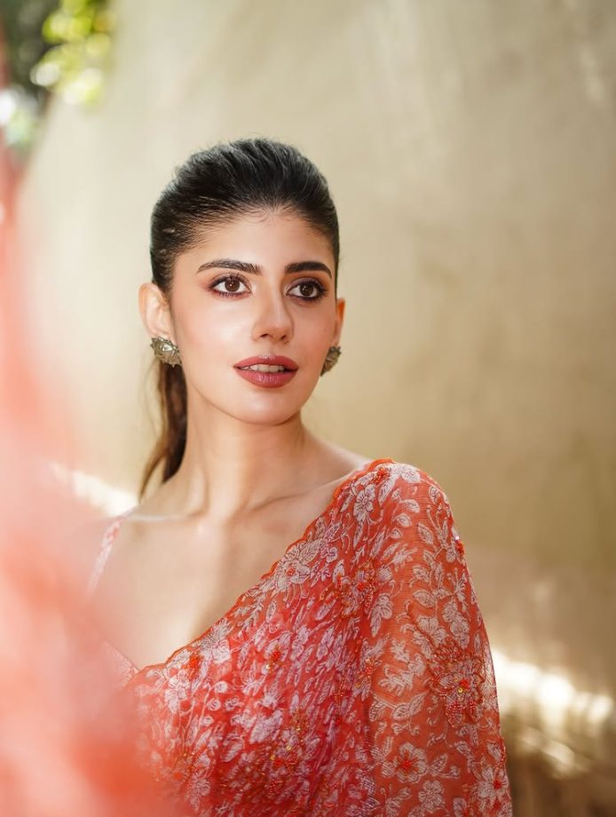 Sanjana Sanghi Shines in Vibrant Orange Floral Saree and Chic Low-Back Blouse 963395