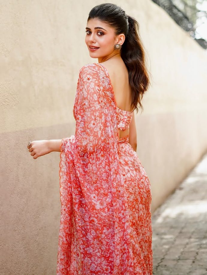 Sanjana Sanghi Shines in Vibrant Orange Floral Saree and Chic Low-Back Blouse 963389