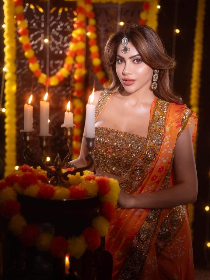 Nikki Tamboli Dazzles in a Fiery Orange Saree 976303