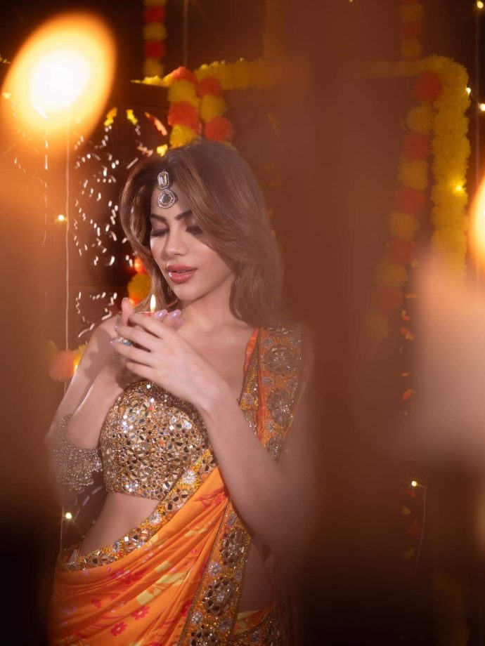 Nikki Tamboli Dazzles in a Fiery Orange Saree 976305